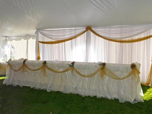 Organza clouds on head table in tent